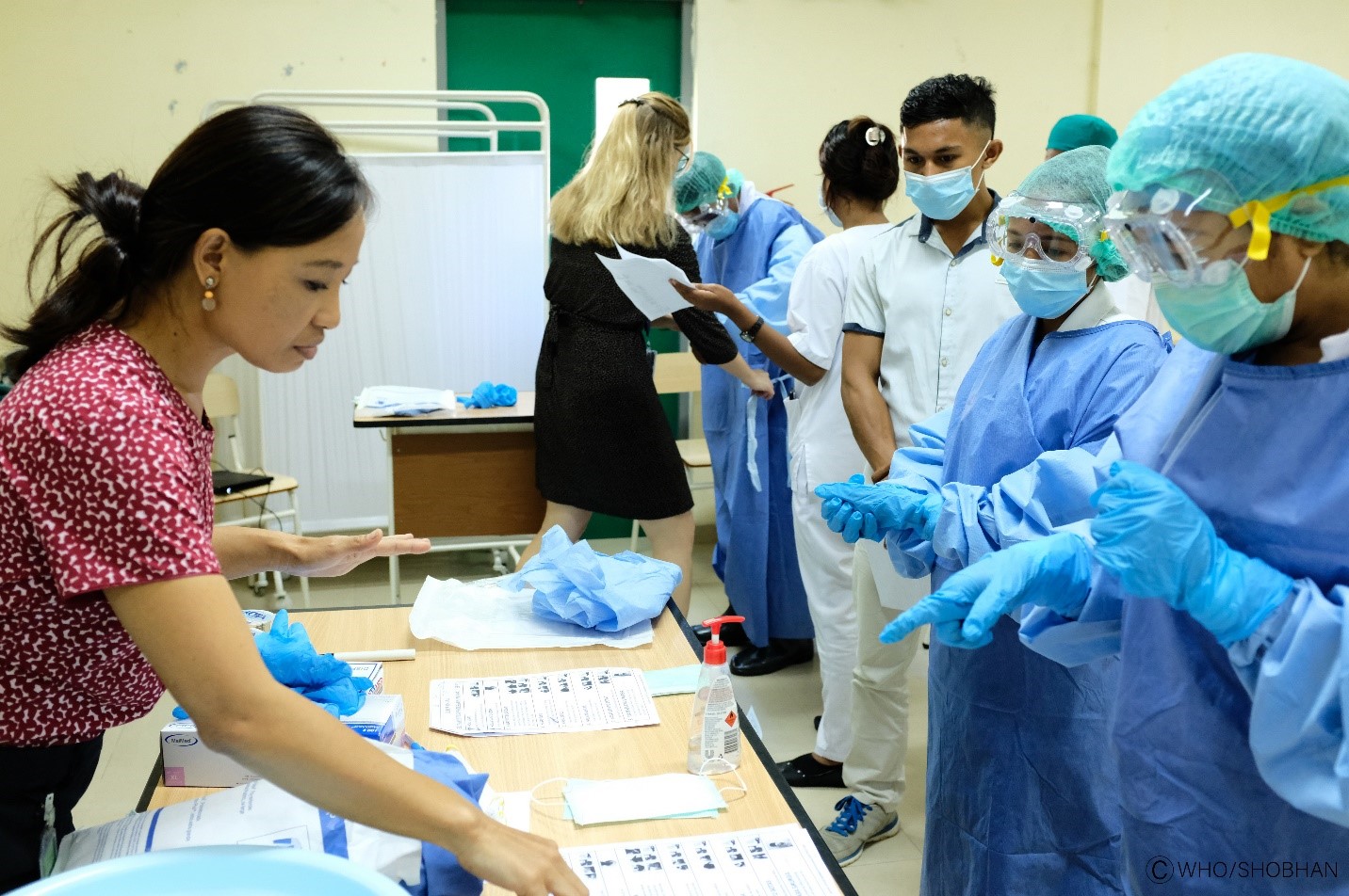 Photo of frontline health workers in Timor-Leste getting trained on PPE use during COVID-19