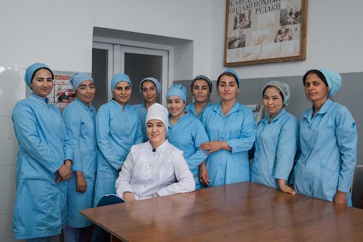 © WHO / Lindsay Mackenzie. Nurses stand for a portrait with their trainer, Dr Shakhlo Abdurakhimovna after a training sesssion at Rudaki District Primary Healthcare Centre.