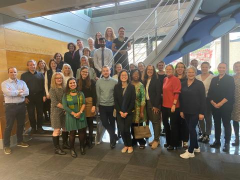 Group photo from workshop Law and Tobacco Control: Global and European perspectives. About 30 people are posing for a photo by a staircase