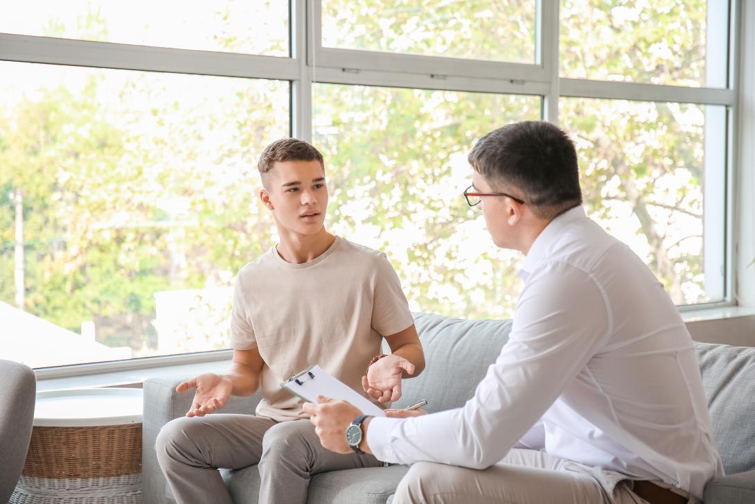man talking to young adult