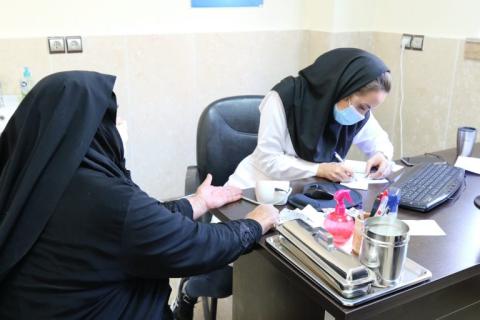  An elderly woman from a rural area receives health services at Afjeh Health House, Shemiranat District, Tehran. September 2020.