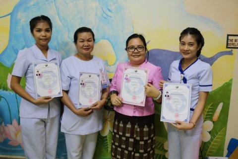 Ms Bounmala Sorpaseut, Deputy Head of Nursing (centre left) and some members of her team at the Children’s Hospital in Vientiane proudly show their registration certificates