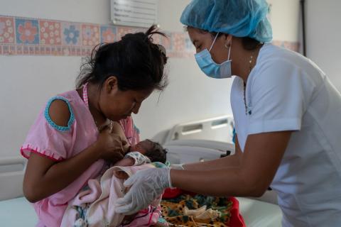 A health worker assists a mother to help facilitate successful breastfeeding at the ESE Hospital de Nazareth in Alta Guajira, Colombia. Photo taken in July 2020