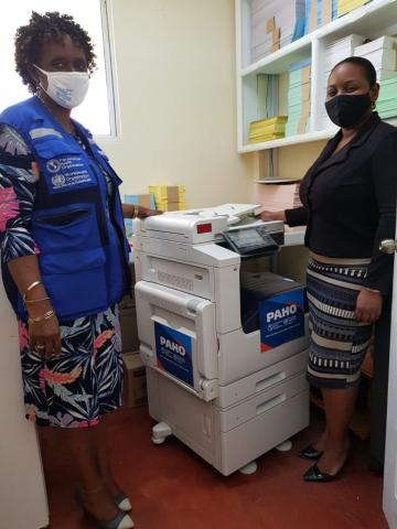 September 2020 – Handover of donated multifunction printer to the Health Information Unit to support provision of weekly EPI report.  From left Anneke Wilson, PAHO Country Program Specialist for Dominica and Ghislene Paul, Statistical Officer, Health Information Unit.