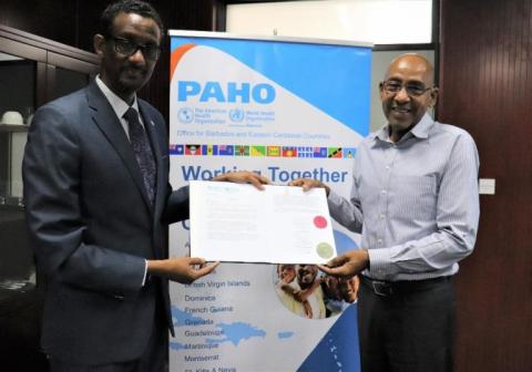 February 2020 – PAHO/WHO Representative for Barbados and the Eastern Caribbean Countries, Dr Yitades Gebre (left) handover of credentials to Dominica Minister of Health, Wellness and New Investment, Dr Irving McIntyre (right)