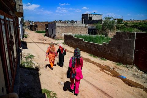 5 May 2019: Health workers walking in a community in the outskirts of Islamabad, Pakistan.