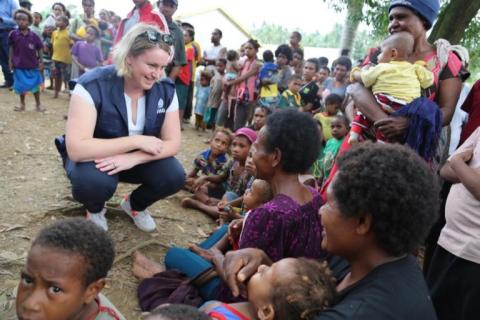 WHO PNG Team Leader for UHC/Health System Strengthening, Anna Maalsen, speaks with mothers during a mass vaccination campaign in a settlement community in Lae, Morobe province.