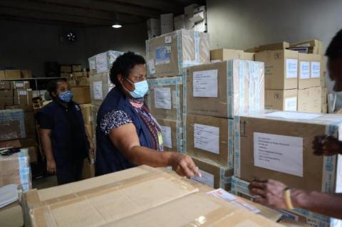 WHO staff in Port Moresby labelling RNA extraction kits to be moved to the Institute of Medical Research in Goroka, to support testing for COVID-19 in PNG
