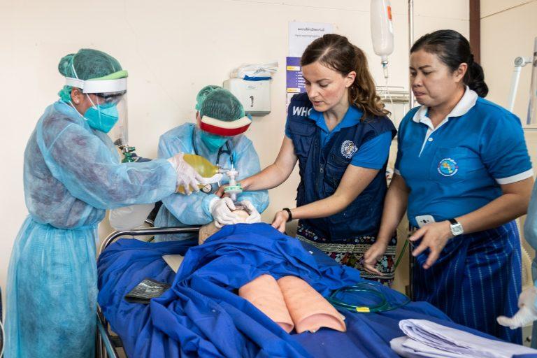 COVID-19: LAO PDR – WHO consultant Dr Rebecca Inglis (second from right) teaches ICU (Intensive Care Unit) staff how to safely use a ventilator on a patient with COVID-19, during a simulation-based training at Setthathirath Hospital.